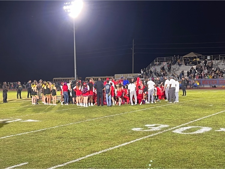 Royal and Sealy teams meet for a prayer after the game. 